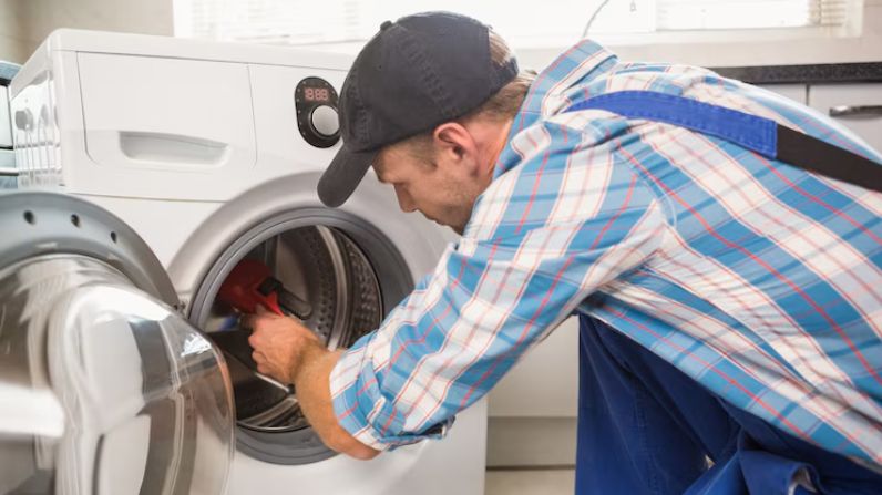 Technician repairing a washing machine in a Bristol home, provided by Affordable Appliances & Repairs