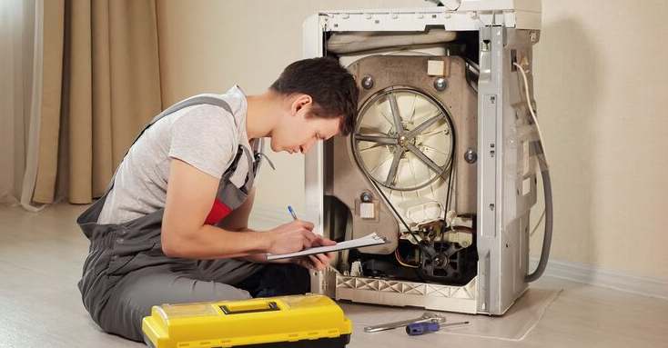 Appliance repair expert fixing washing machine in Bristol